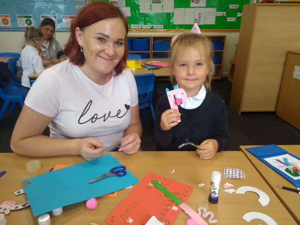 Photo of mum and child showing craft