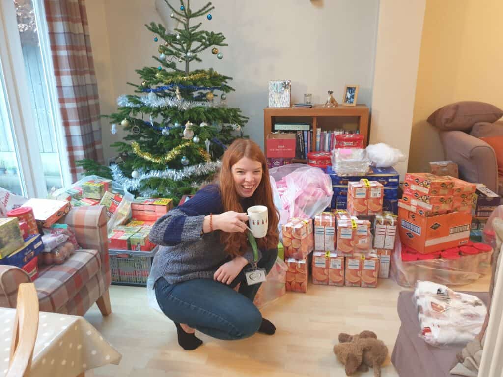 Lady in front of a christmas tree and parcels