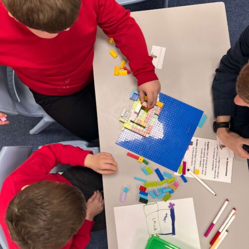 Building Lego structures with children in a classroom setting.