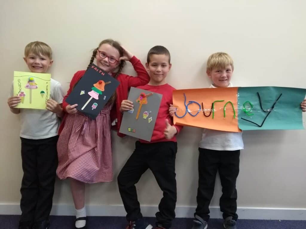 Children posing with craft
