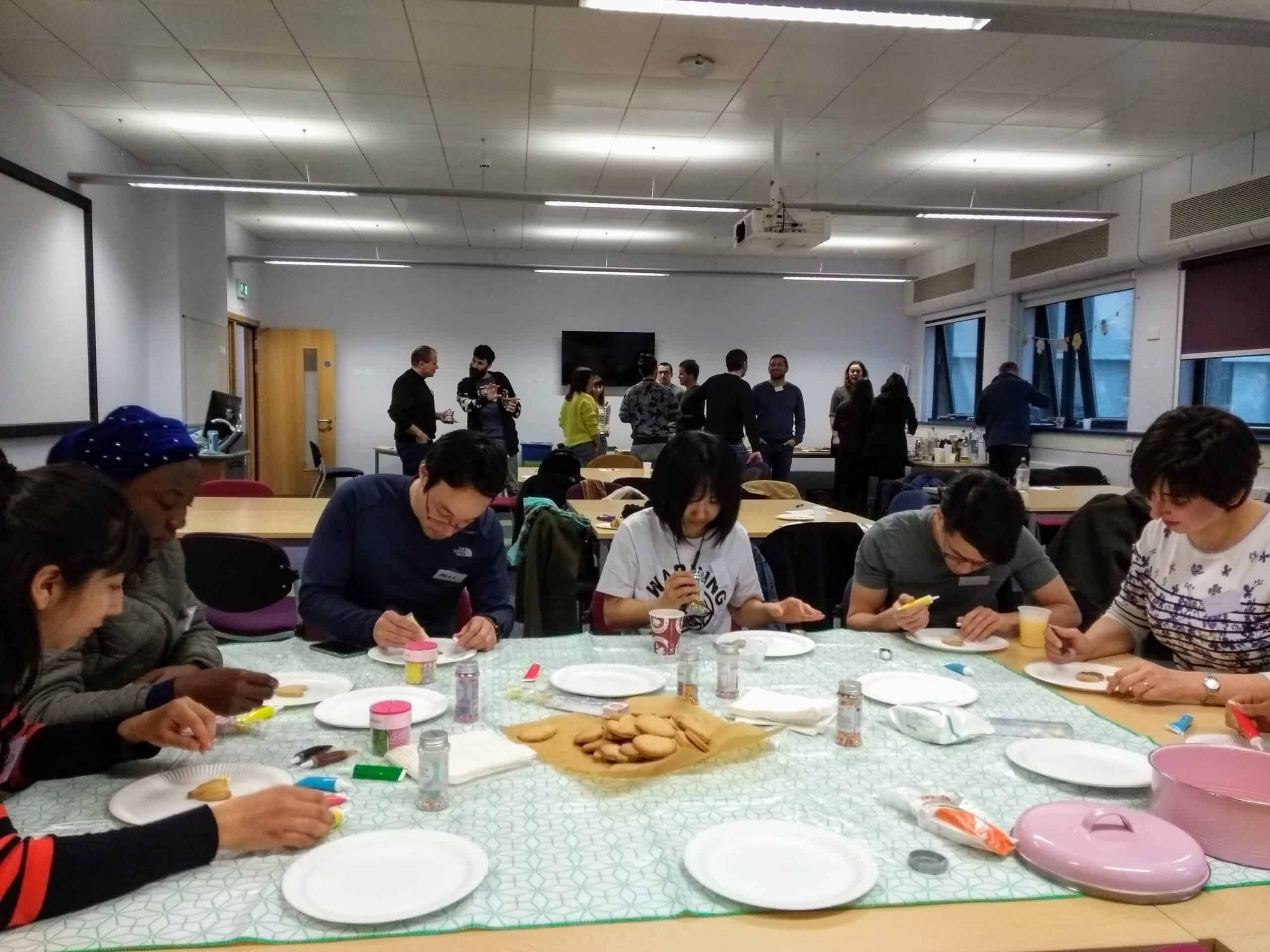 Group of people icing biscuits