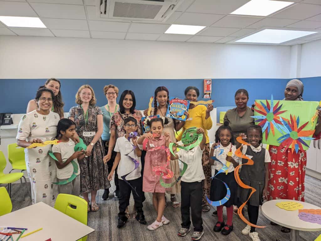 Group photo of people holding up craft